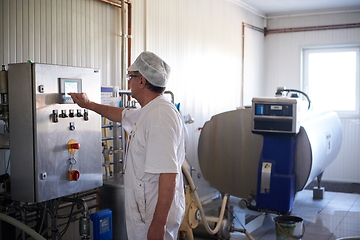 Image showing Cheese production cheesemaker working in factory