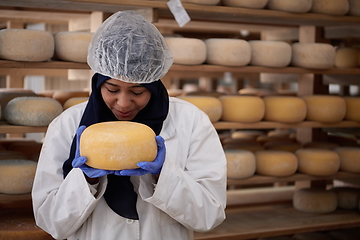 Image showing African black muslim business woman in local cheese production company