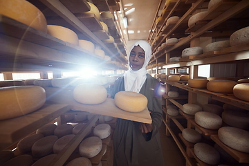 Image showing African black muslim business woman in local cheese production company