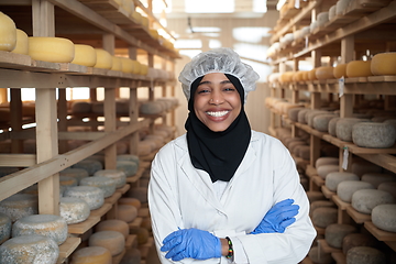 Image showing African black muslim business woman in local cheese production company