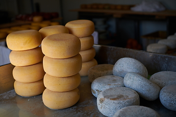 Image showing Cheese factory production shelves with aging old cheese