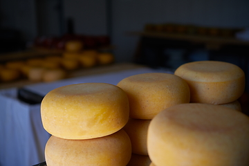 Image showing Cheese factory production shelves with aging old cheese