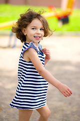 Image showing Little girl is playing in playground