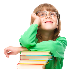 Image showing Little girl is reading a book