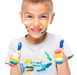 Image showing Portrait of a cute boy playing with paints