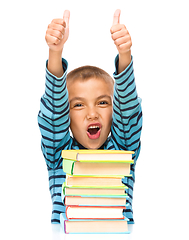 Image showing Little boy is reading a book