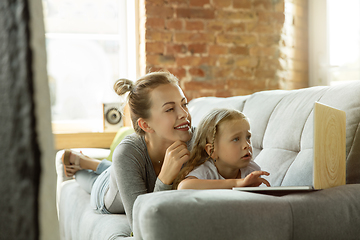 Image showing Teacher and little girl, or mom and daughter. Homeschooling concept