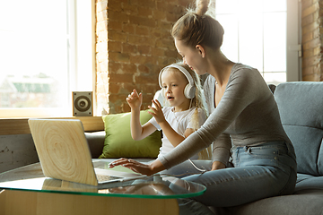 Image showing Teacher and little girl, or mom and daughter. Homeschooling concept