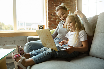 Image showing Teacher and little girl, or mom and daughter. Homeschooling concept