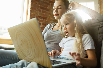 Image showing Teacher and little girl, or mom and daughter. Homeschooling concept