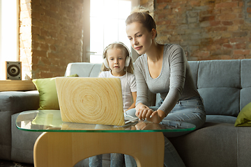 Image showing Teacher and little girl, or mom and daughter. Homeschooling concept