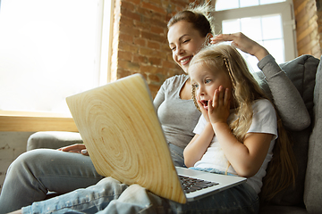 Image showing Teacher and little girl, or mom and daughter. Homeschooling concept