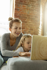 Image showing Teacher and little girl, or mom and daughter. Homeschooling concept