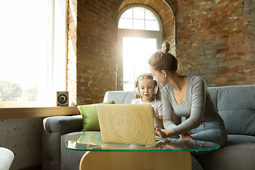 Image showing Teacher and little girl, or mom and daughter. Homeschooling concept