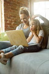 Image showing Teacher and little girl, or mom and daughter. Homeschooling concept