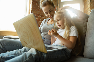 Image showing Teacher and little girl, or mom and daughter. Homeschooling concept