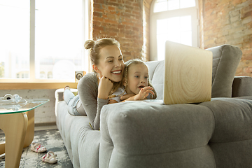 Image showing Teacher and little girl, or mom and daughter. Homeschooling concept