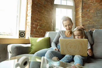 Image showing Teacher and little girl, or mom and daughter. Homeschooling concept