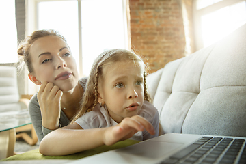 Image showing Teacher and little girl, or mom and daughter. Homeschooling concept