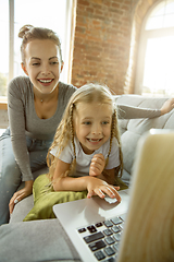 Image showing Teacher and little girl, or mom and daughter. Homeschooling concept