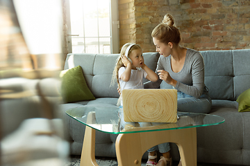 Image showing Teacher and little girl, or mom and daughter. Homeschooling concept