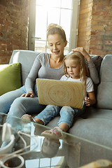 Image showing Teacher and little girl, or mom and daughter. Homeschooling concept