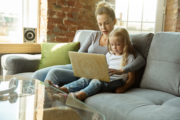 Image showing Teacher and little girl, or mom and daughter. Homeschooling concept