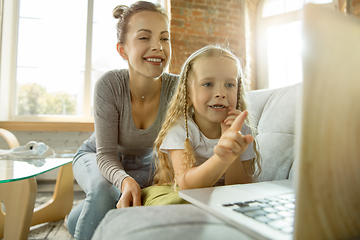 Image showing Teacher and little girl, or mom and daughter. Homeschooling concept