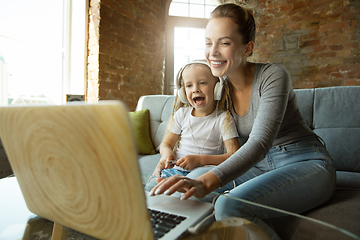 Image showing Teacher and little girl, or mom and daughter. Homeschooling concept