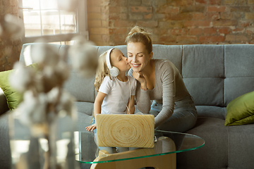 Image showing Teacher and little girl, or mom and daughter. Homeschooling concept