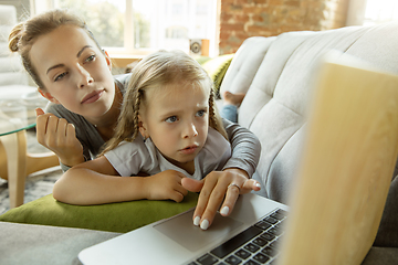 Image showing Teacher and little girl, or mom and daughter. Homeschooling concept