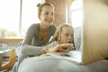 Image showing Teacher and little girl, or mom and daughter. Homeschooling concept