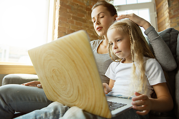 Image showing Teacher and little girl, or mom and daughter. Homeschooling concept