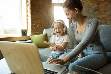 Image showing Teacher and little girl, or mom and daughter. Homeschooling concept