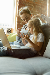 Image showing Teacher and little girl, or mom and daughter. Homeschooling concept