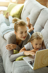 Image showing Teacher and little girl, or mom and daughter. Homeschooling concept