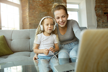 Image showing Teacher and little girl, or mom and daughter. Homeschooling concept