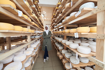 Image showing African black muslim business woman in local cheese production company