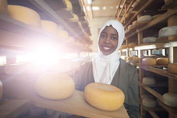 Image showing African black muslim business woman in local cheese production company