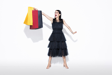 Image showing Young woman in dress shopping on white background