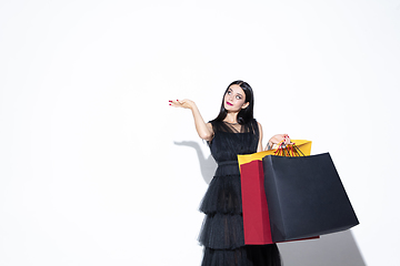 Image showing Young woman in dress shopping on white background