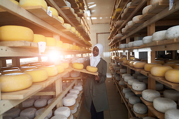 Image showing African black muslim business woman in local cheese production company