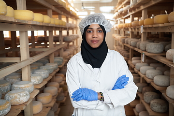 Image showing African black muslim business woman in local cheese production company