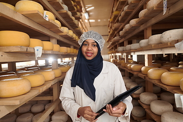 Image showing African black muslim business woman in local cheese production company