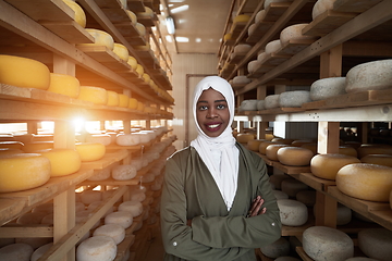 Image showing African black muslim business woman in local cheese production company