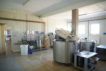 Image showing Cheese factory production shelves with aging old cheese