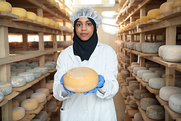 Image showing African black muslim business woman in local cheese production company