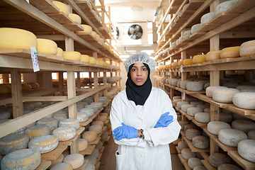 Image showing African black muslim business woman in local cheese production company