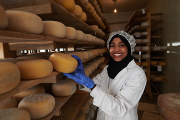 Image showing African black muslim business woman in local cheese production company