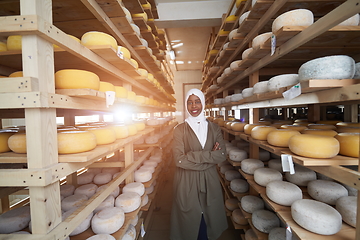 Image showing African black muslim business woman in local cheese production company